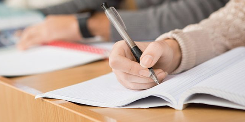 person writing in book