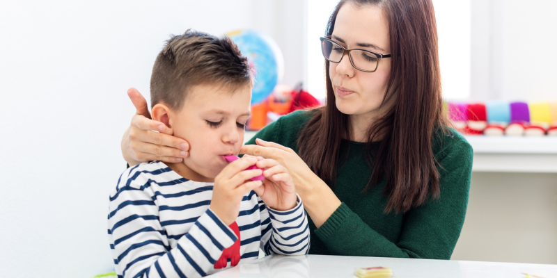 boy and speech pathologist