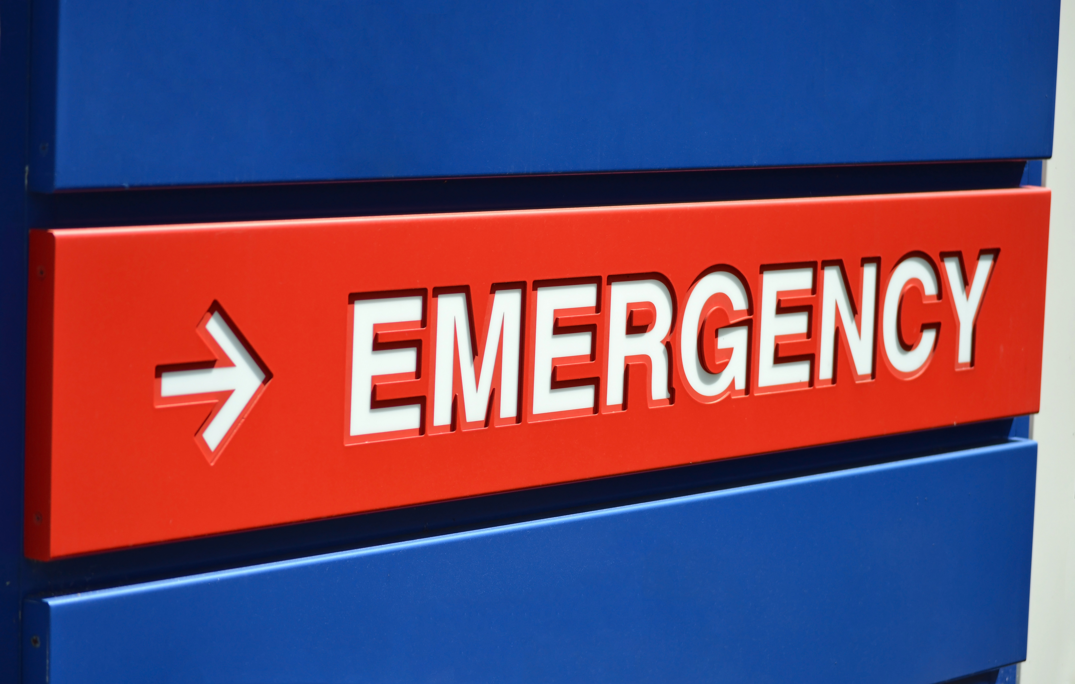 Red emergency sign set into a blue wall