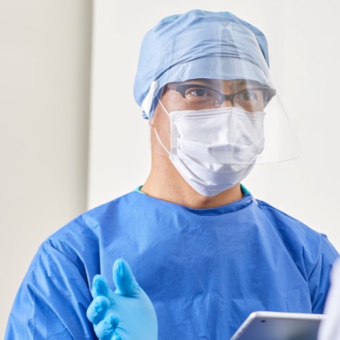 Surgeon wearing face shield