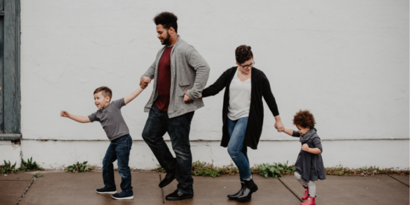 Family holding hands walking along