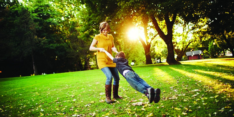 Woman swinging child