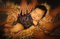 baby with hands surrounding