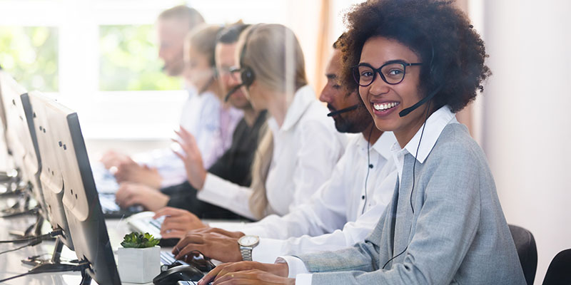 Call centre staff at computers with headsets