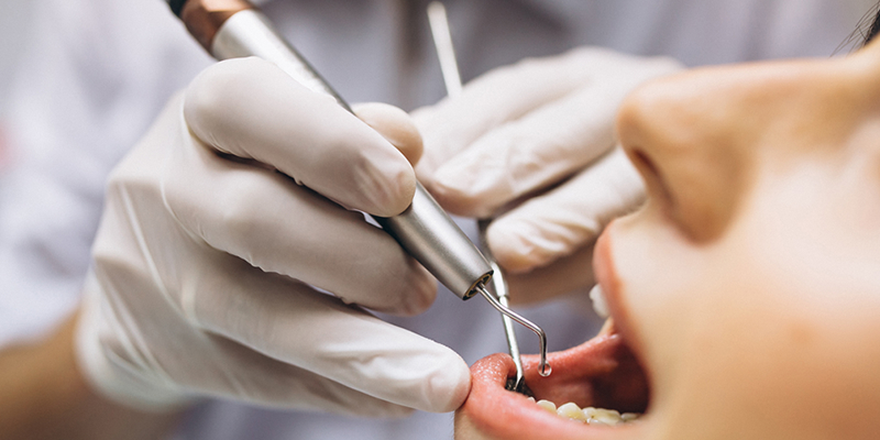 Dentist working with tools