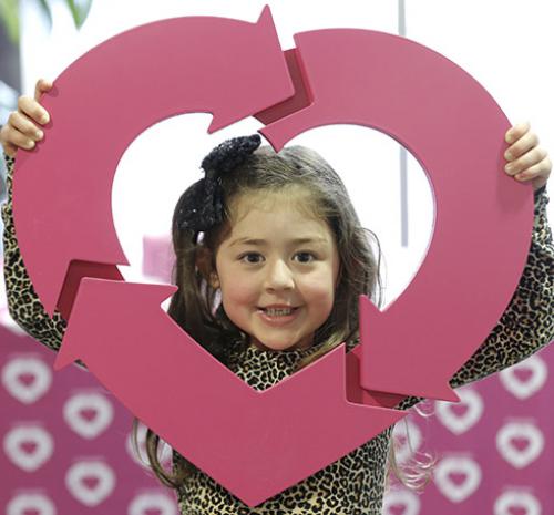 Young girl holding the donate life logo