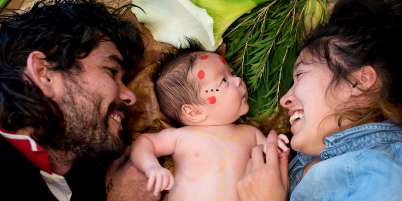 parents with baby on ground