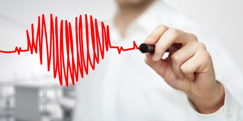 Man drawing a heart image with a red marker