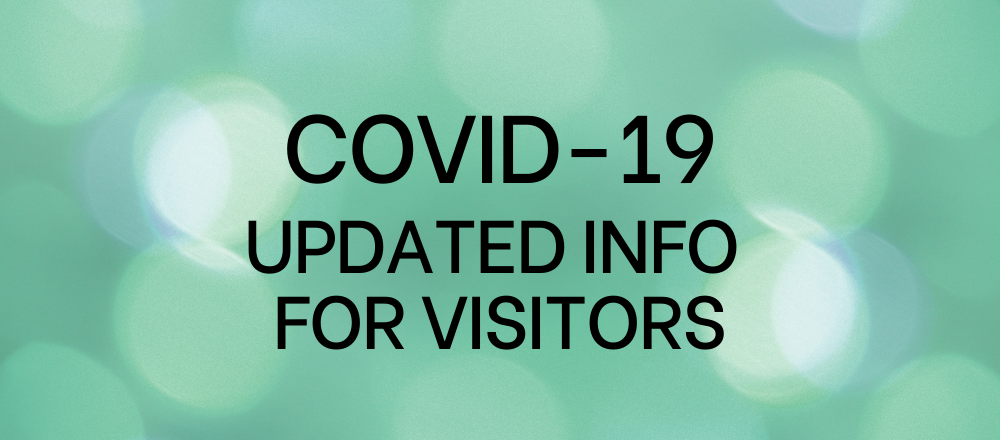 Green background with the words covid-19 updated info for visitors