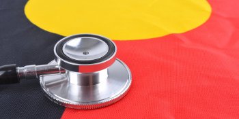 Aboriginal flag with stethoscope laying on top