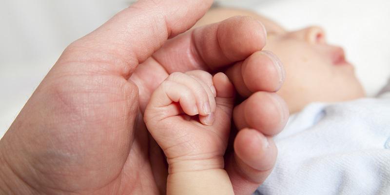 Holding newborn's hand