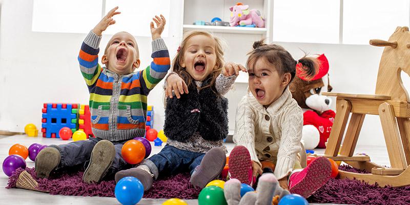 Three children in a playroom