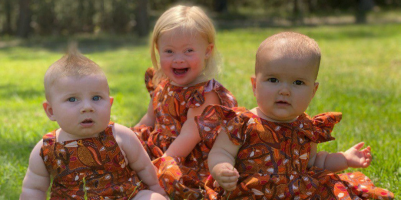 Three toddlers smiling