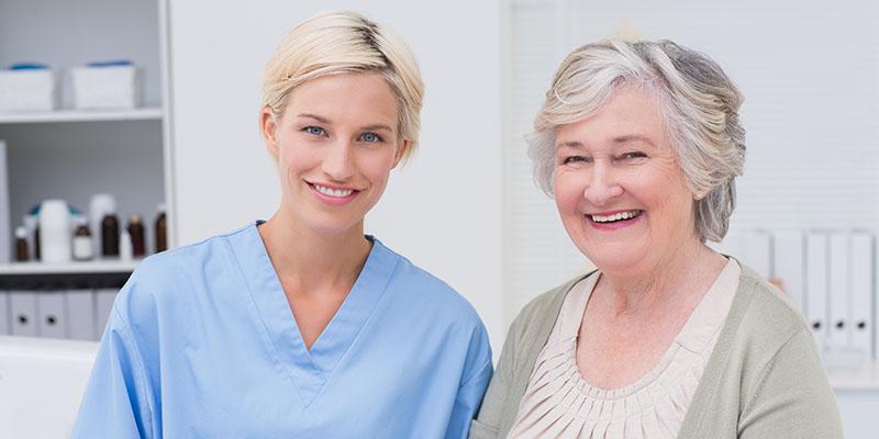 Image of a nurse and patient smiling