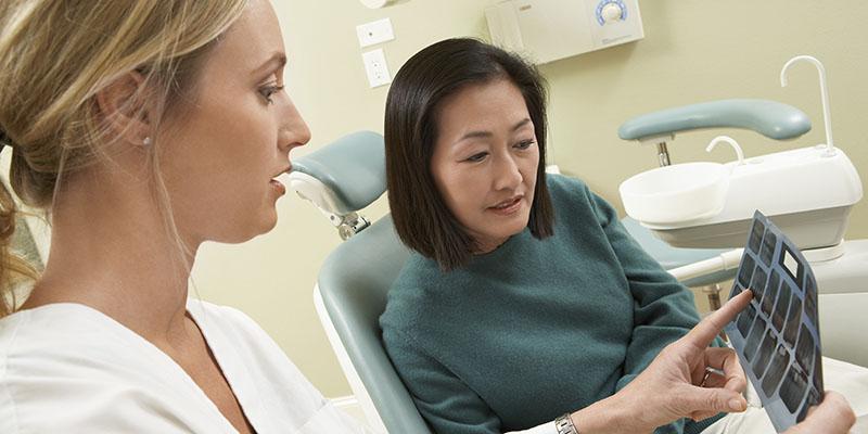 Image of a doctor showing scans to a female patient