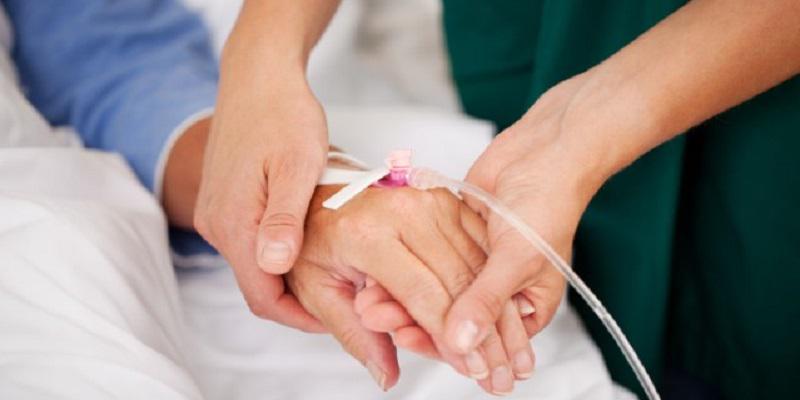 Patient hand being held by a staff member