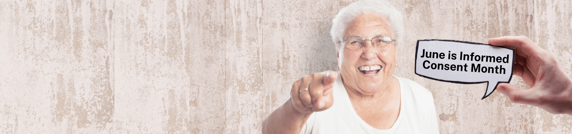 Older adult woman stares straight ahead and points forward. Hand holds a sign that says June is Informed Consent Month.