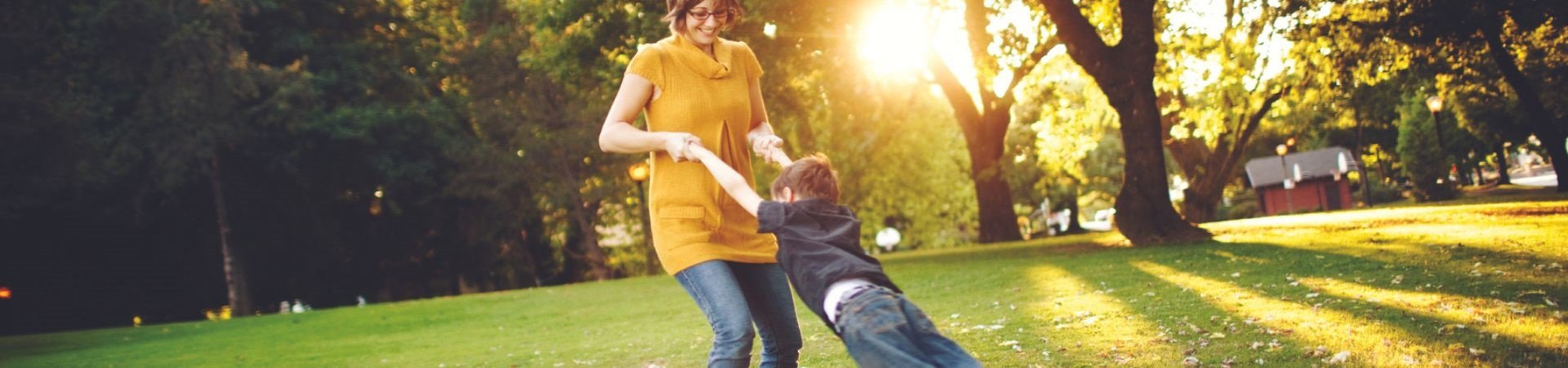 woman swinging young child