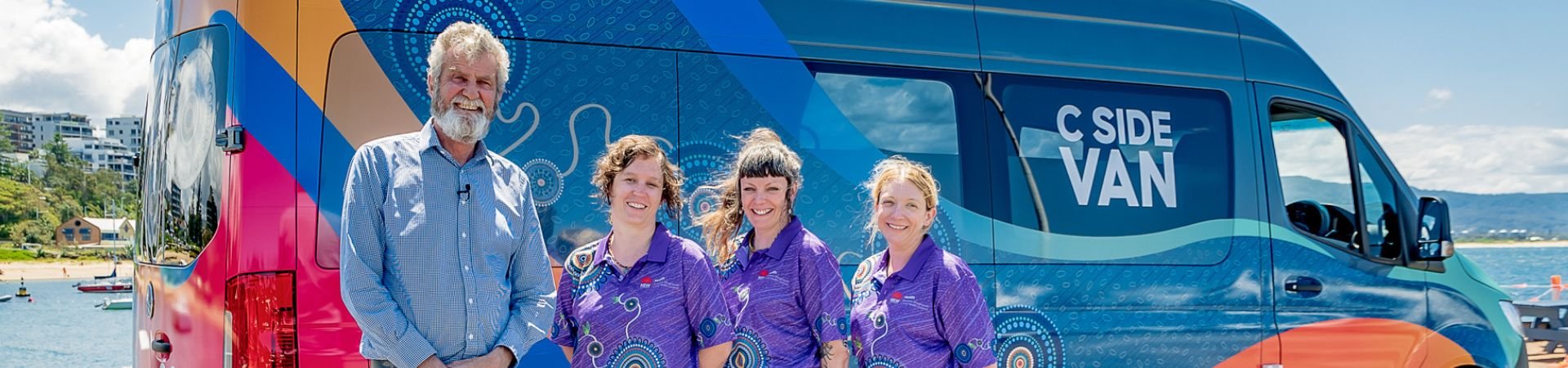 The C-Side van at the beach with staff.